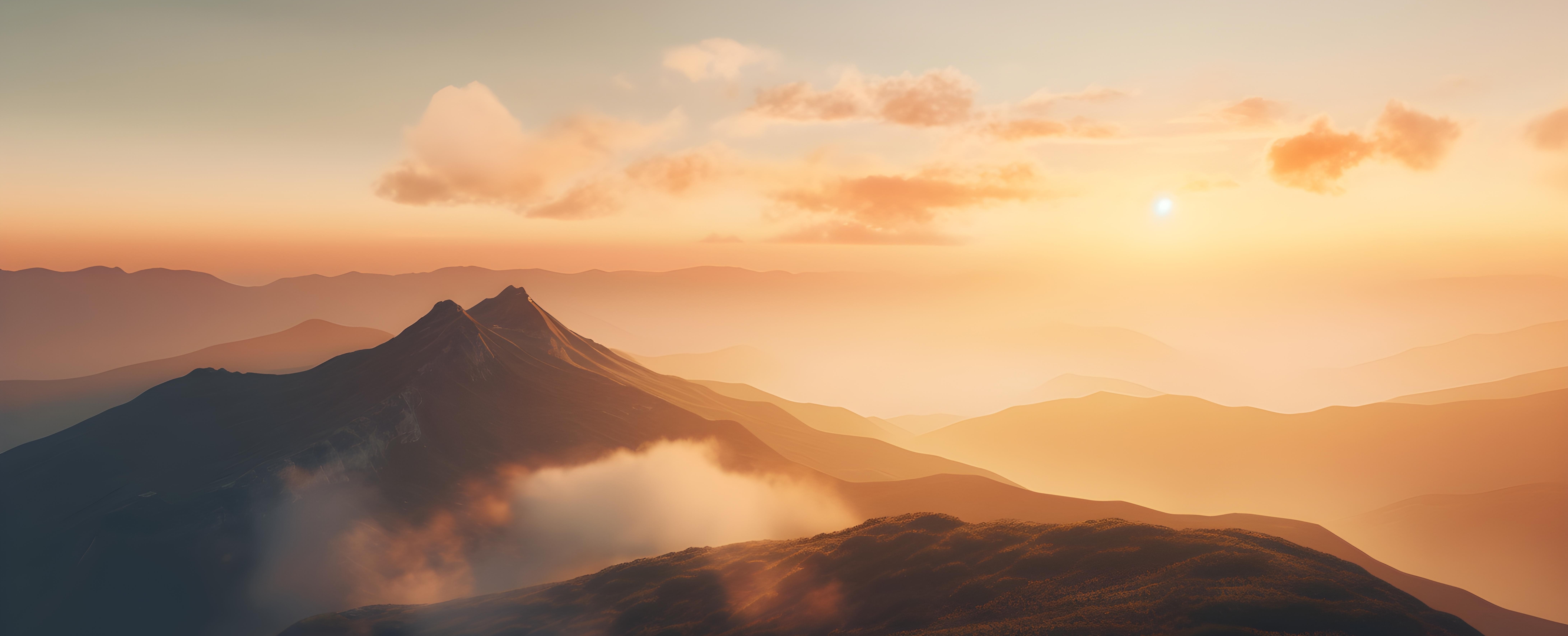 sweeping mountains under a pink sunset with whispy clouds